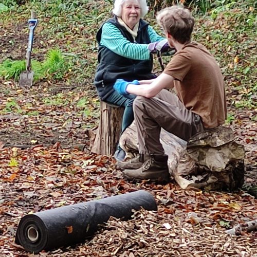 Carol and Benedict put the world to rights Volunteers taking it easy on log seating